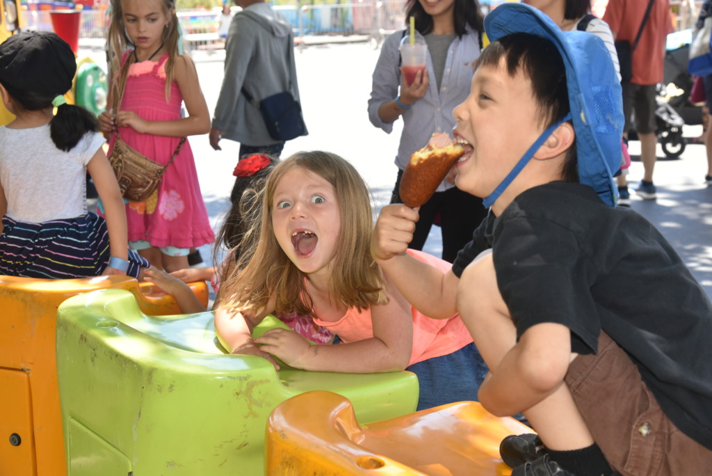 children playing games at the san mateo fair